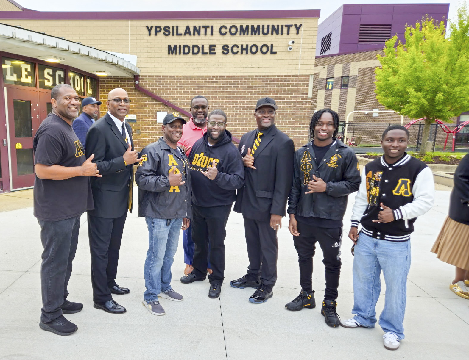 Community volunteers gathered outside Ypsilanti Community Middle School for a student clap-in