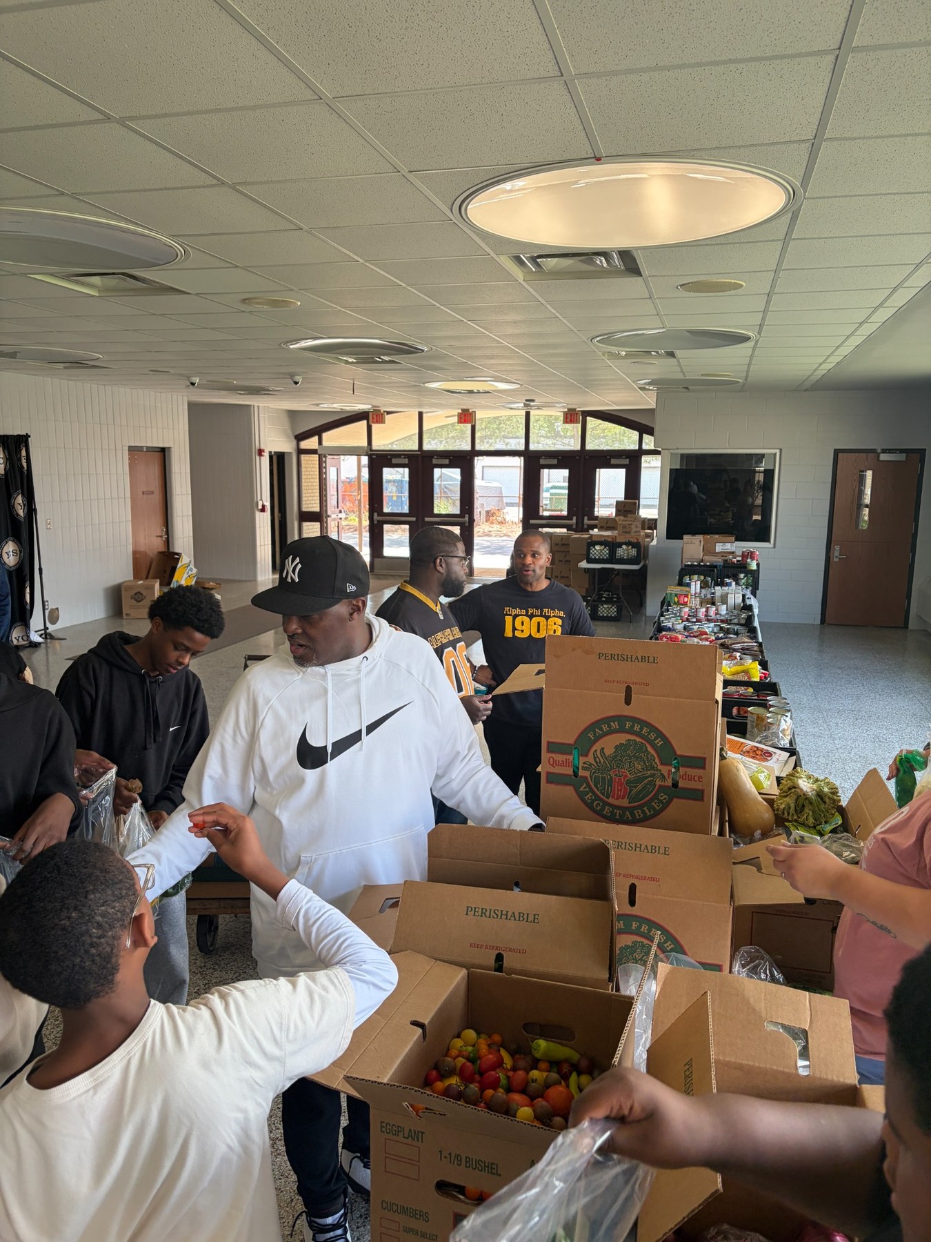 Volunteers organizing produce and pantry items at the YCMS Healthy School Pantry
